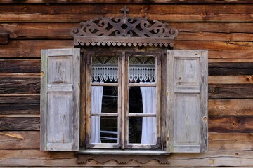 Close up of windows with wooden shutters in traditional cottage in Kurpie, culture region of Poland