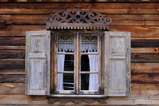 Close up of windows with wooden shutters in traditional cottage in Kurpie, culture region of Poland