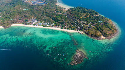 Long beach and Blacktip Reef Shark Point, Phi Phi island, Krabi, Thailand. Aerial view of a tropical island surrounded by coral reef. 