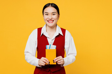 Traveler corporate lawyer employee business woman wear red vest shirt hold passport ticket isolated on plain yellow background. Tourist travel abroad in free time rest getaway Air flight trip concept