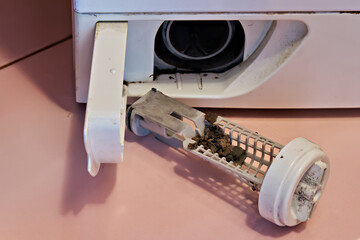 Demonstration of a dirty and clogged washing machine pump filter. Do-it-yourself repair of...