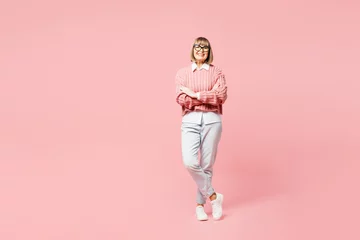 Fotobehang Full body elderly woman 50s years old wear sweater shirt casual clothes glasses hold hands crossed folded look camera isolated on plain pastel light pink background studio portrait. Lifestyle concept. © ViDi Studio