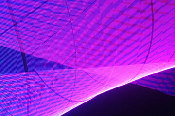 Large display featuring a pattern of pink lights radiating outward along distinct lines