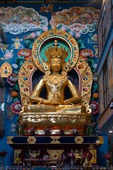 Fototapeta na wymiar Sculpture of Maitreya Buddha in the Buddha Temple of the Namdroling Monastery in Karnataka, India