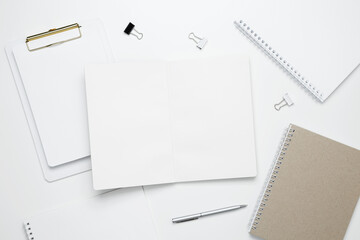 Creative flat lay mockup design of workspace. Top view composition with white notebook