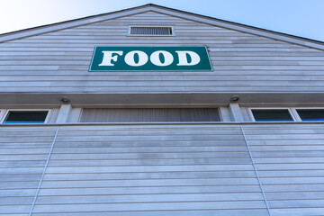 A building with a green sign that says food on it