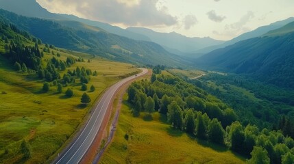 Aerial top view beautiful curve road on green forest in the rain season.