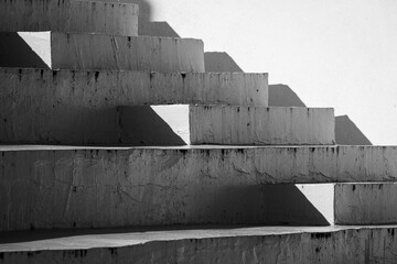 Grayscale shot of concrete geometric stairs on a light background