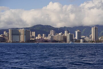 City and mountain view of the shore at Waikiki Beach in Honolulu, Hawaii