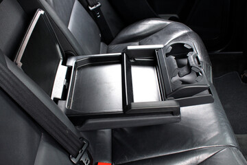 Modern car central opened armrest for rear seat passengers with cup holders. Rear passenger...