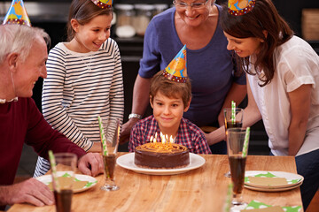 Family, birthday cake and smile of boy, parents and grandparents together with youth and candles....
