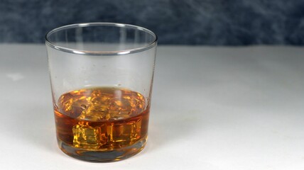 Closeup of a glass of whiskey on a table