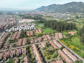 Fototapeta na wymiar Aerial view of a residential area surrounded by lush greenery. Chia, Cundinamarca, Colombia.