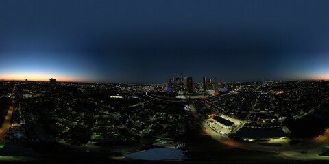 Panoramic view of the vibrant Houston skyline at night with illuminated buildings across the horizon