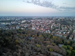 Cityscape of Plovdiv with lush wooden area in the foreground. Bulgaria.