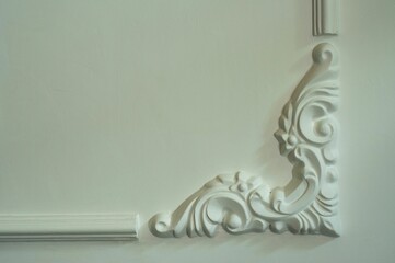 White decorative ornament displayed against a wall in a room