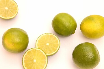 a group of limes, on a white surface, in a circle