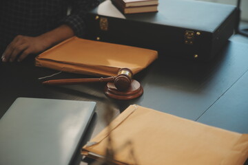 Justice and Law concept. Legal counsel presents to the client a signed contract with gavel and...