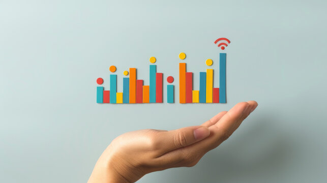A conceptual image of a hand seemingly holding a vibrant, three-dimensional bar graph with a Wi-Fi symbol above, signifying growth and connectivity.