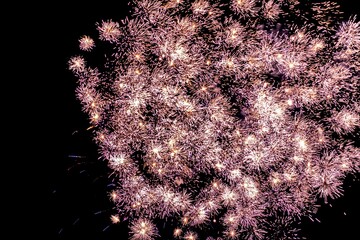 a large multicolored fireworks is seen in the air