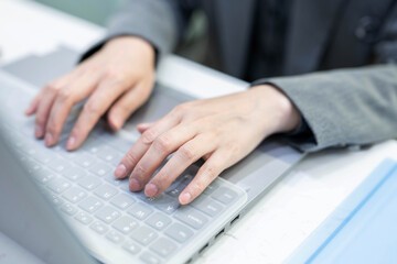 hands working on laptop keyboard