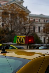 Close-up shot of a taxi cab sign on a taxi car in the city center