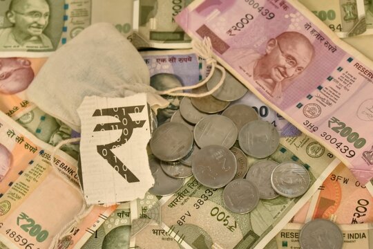 A closeup selective focus of an Indian digital currency with currency notes and Coins