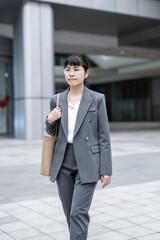 Commuting white-collar workers under the office building in Guangzhou City CBD