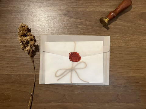old envelope with red wax seal and dried flowers, flat lay composition