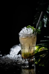 Close-up shot of a glass of mojito on dark background