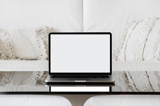 Modern laptop on the table with copyspace in a modern living room