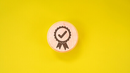 Quality warranty icon on wooden tube on yellow background. Used for banners and advertising product...