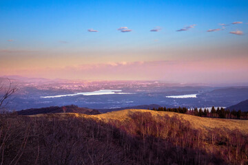 Warm colors at sunset. Suggestive winter landscape, with hills illuminated by the rays of the...