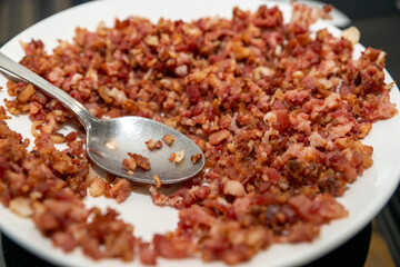 A plate full of bacon bits as a salad topping