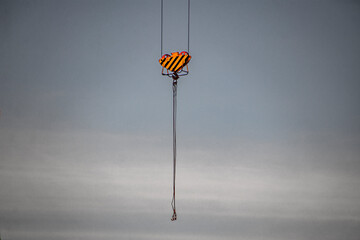 Boom of a construction crane against a gray sky