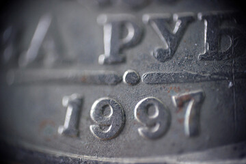 The inscription 1997 on the coin in macro	
