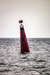 Big red buoy floats in the sea	
