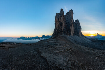 Panoramic photo of the famous Tre Cime peak in the Italian Dolomites in early autumn and the golden hour glow of the setting sun