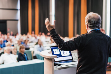 Speaker at Business Conference with Public Presentations. Audience at the conference hall. Business and Entrepreneurship concept. Rear view. Panoramic composition. Background blur. - 769787456