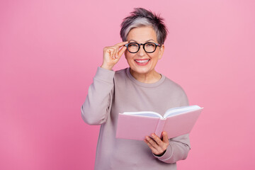 Photo of cheerful adorable retired woman wear stylish clothes reading novel poetry book textbook...