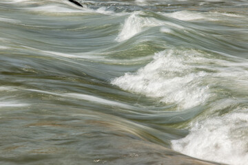Closeup of Motion-Blurred Water Rapids Flowing of a river.