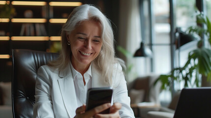 Middle aged Caucasian business manager ceo using smartphone and laptop in office working with copy space