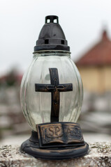 Close-up of candle jar on a tombstone in a cemetery