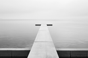 Minimalist jetty extending into calm grey waters under overcast sky - Powered by Adobe
