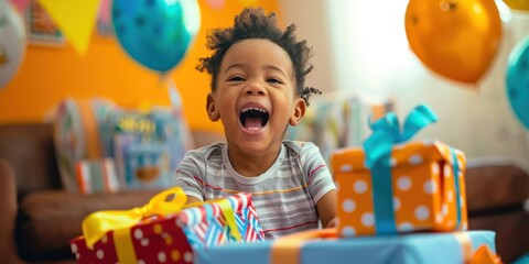 A child opening birthday presents with excitement and joy. 