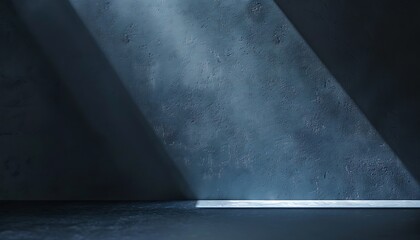 Blue concrete wall with spotlight from above and concrete floor in dark room