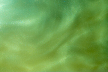 Green Shiny Abstract Background. Paints, Acrylic, Glitter in Water