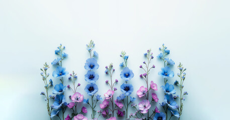 A blue and pink flower arrangement is displayed on a white background. The flowers are arranged in a way that creates a sense of depth and dimension. blue and purple flowers set in a white background