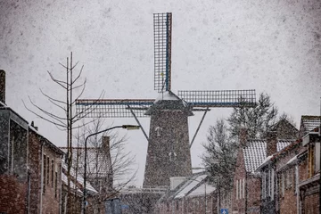 Foto auf Leinwand Dutch Windmill in snow storm © Marcel Otterspeer
