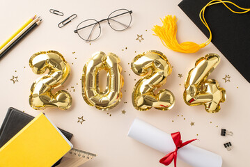 Graduation celebration concept. Top view of 2024 shimmering balloons, graduation cap, diploma, study essentials, writing materials, books, glasses, glimmering confetti, tinsel on soft beige background